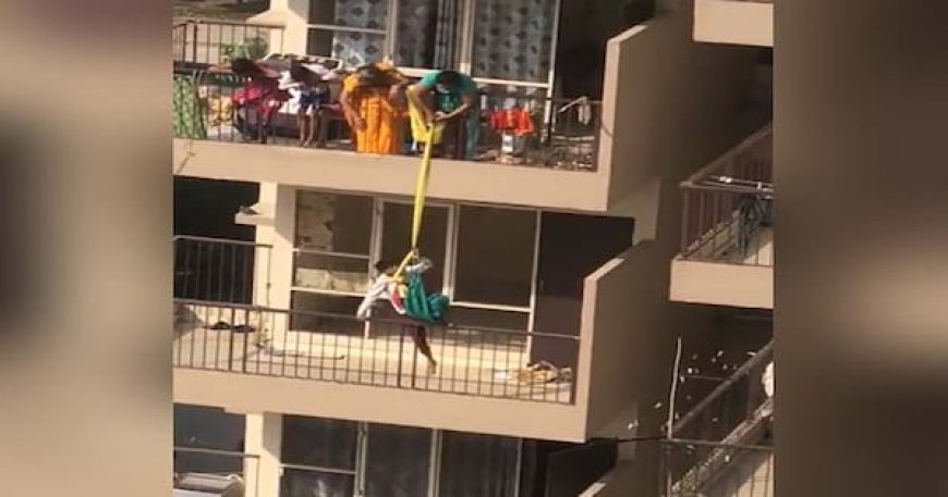 Woman dangles son by saree from 10th floor to fetch fallen saree: video link below